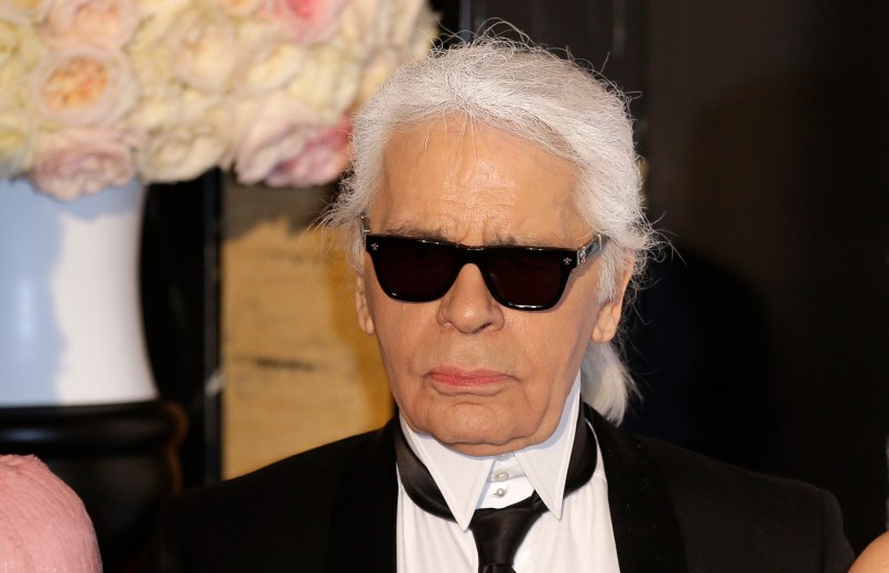 FILE - In this Saturday, March 28, 2015 file photo, Karl Lagerfeld poses for photographers as he arrives at the Rose Ball in Monaco. The Rose Ball is the traditional annual charity event in the Principality of Monaco. Chanel¿s iconic couturier, Karl Lagerfeld, whose accomplished designs as well as trademark white ponytail, high starched collars and dark enigmatic glasses dominated high fashion for the last 50 years, has died. He was around 85 years old. (AP Photo/Lionel Cironneau, File) France Obit Lagerfeld
