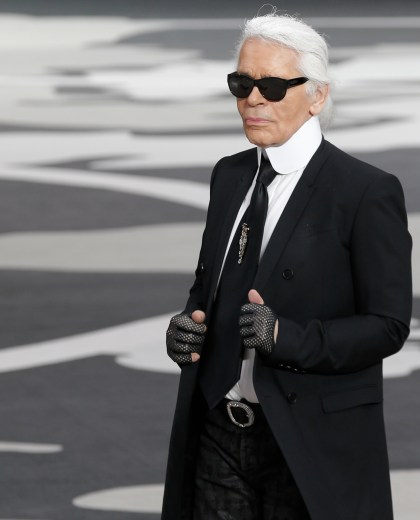 FILE - A Tuesday, March, 5, 2013 photo of German fashion designer Karl Lagerfeld acknowledging applause at the end of his Fall/Winter 2013-2014 ready to wear collection for Chanel presented in Paris. Chanel's iconic couturier, Karl Lagerfeld, whose accomplished designs as well as trademark white ponytail, high starched collars and dark enigmatic glasses dominated high fashion for the last 50 years, has died. He was around 85 years old. (AP Photo/Christophe Ena, File) France Obit Lagerfeld