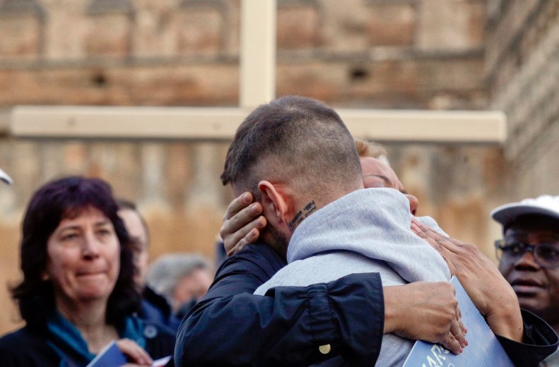 Sex abuse survivor Alessandro Battaglia, right, is hugged by survivor and founding member of the ECA (Ending Clergy Abuse), Denise Buchanan, during a twilight vigil prayer near Castle Sant' Angelo, in Rome, Thursday, Feb. 21, 2019. Pope Francis opened a landmark sex abuse prevention summit Thursday by warning senior Catholic figures that the faithful are demanding concrete action against predator priests and not just words of condemnation. (AP Photo/Gregorio Borgia) Vatican Sex Abuse