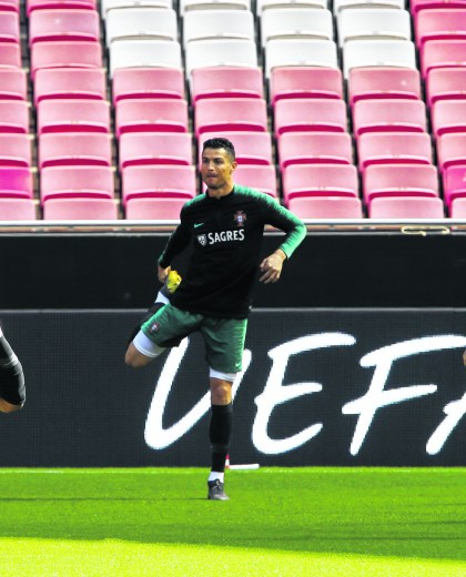 Portugal's Cristiano Ronaldo, center, exercises during a training session of the Portuguese soccer team at the Luz stadium in Lisbon, Thursday, March 21, 2019. Portugal will play Ukraine in a Euro 2020 qualifying match March 22. (AP Photo/Armando Franca)