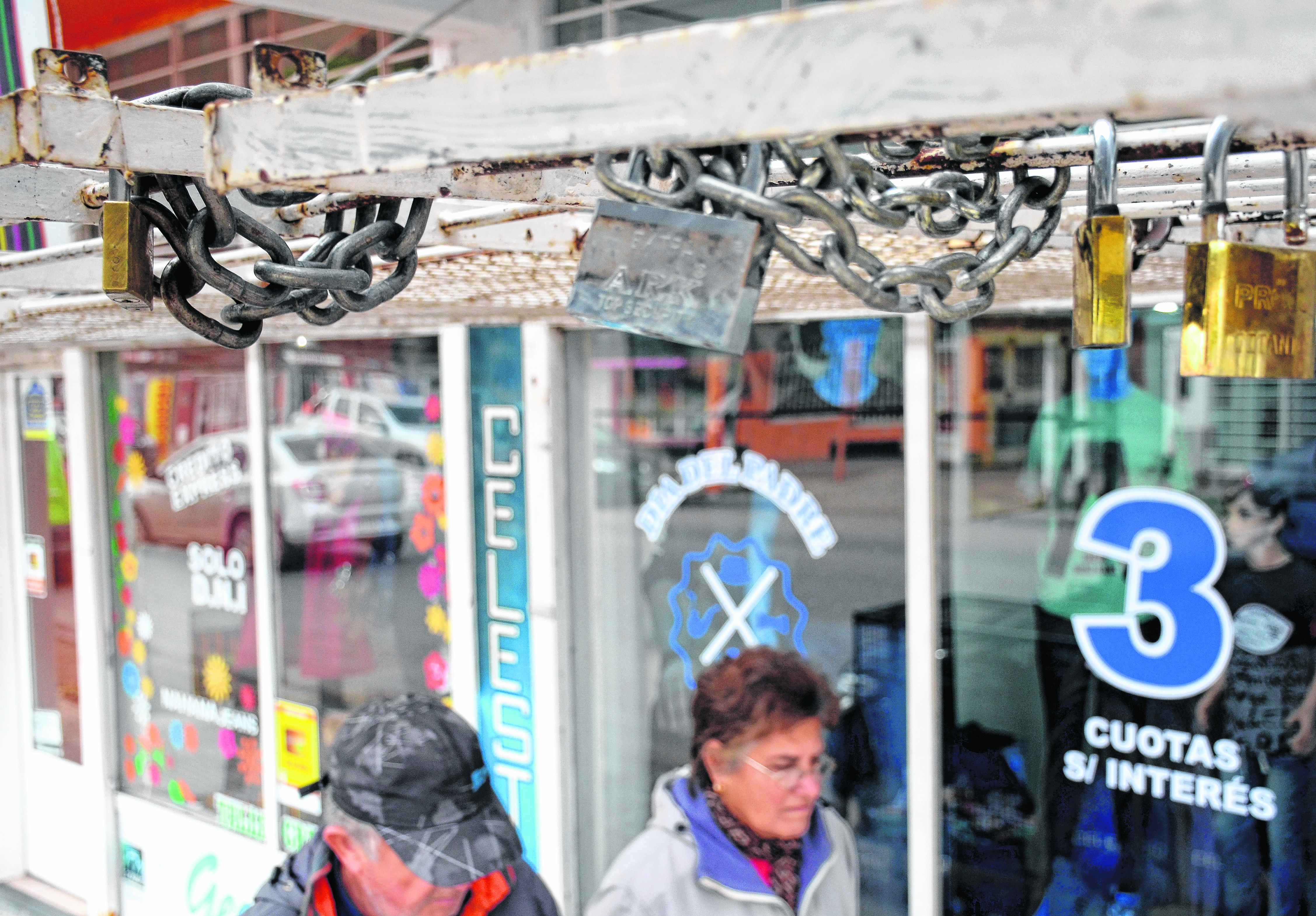 Con rejas, cadenas y candados, los comerciantes intentan proteger sus vidrieras por las noches. Foto: Mauro Pérez