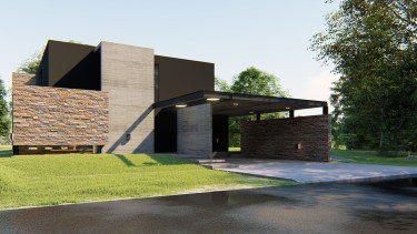 La fachada, un muro ciego de piedra y hormigón. De forma no frontal, está la puerta de ingreso.