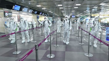 FILE - In this March 6, 2020, file photo, South Korean army soldiers wearing protective suits spray disinfectant to prevent the spread of the new coronavirus at Daegu International Airport in Daegu, South Korea. As cases of the coronavirus surge in Italy, Iran, South Korea, the U.S. and elsewhere, many scientists say it's plain that the world is in the grips of a pandemic  a serious global outbreak.  (Kim Joo-sung/Yonhap via AP)