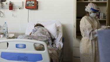 Un paciente con coronavirus, tendido en una cama en el hospital Eurnekian Ezeiza en Buenos Aires. Foto: Natacha Pisarenko para AP.-