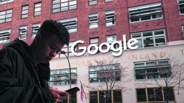 FILE - In this Dec. 17, 2018, file photo a man using a mobile phone walks past Google offices in New York. Australia’s laws forcing Google and Facebook to pay for news are ready to take effect, though the laws' architect said it will take time for the digital giants to strike media deals. The Parliament on Thursday, Feb . 25, 2021, passed amendments to the so-called News Media Bargaining Code agreed between Treasurer Josh Frydenberg and Facebook chief executive Mark Zuckerberg on Tuesday. (AP Photo/Mark Lennihan, File)