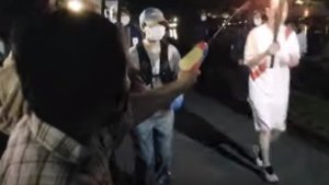 Video: una mujer intentó apagar la antorcha olímpica con una pistola de agua