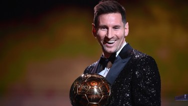 Paris Saint-Germain's Argentine forward Lionel Messi reacts after being awarded the the Ballon d'Or award during the 2021 Ballon d'Or France Football award ceremony at the Theatre du Chatelet in Paris on November 29, 2021. (Photo by FRANCK FIFE / AFP)