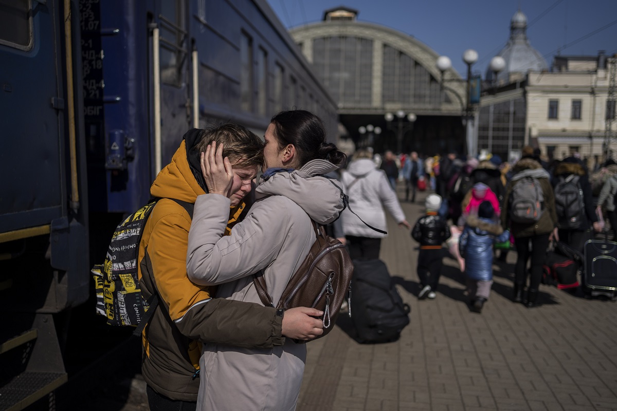 Una madre abraza a su hijo que escapó de la ciudad sitiada de Mariupol y llegó a la estación de tren de Lviv, en el oeste de Ucrania. Foto AP. 