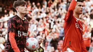 Cristiano Ronaldo festeja a la salida de la cancha y atrás le lleva la pelota por el hat-trick el pibe argentino de 17 años Alejandro Garnacho, que fue suplente. 