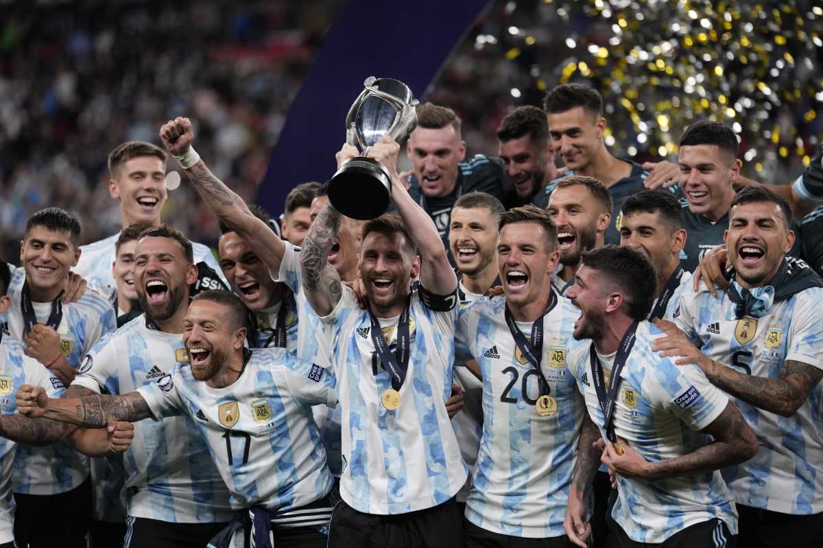 Argentina's Lionel Messi holds a trophy as he celebrates with his teammates after winning the Finalissima soccer match between Italy and Argentina at Wembley Stadium in London , Wednesday, June 1, 2022. Argentina won 3-0. (AP Photo/Matt Dunham)