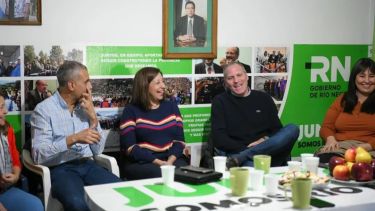 Banacloy, Carreras, Palmieri y Reynoso sonrientes en el local roquense de Juntos. Detrás, la imagen seria de Weretilneck.