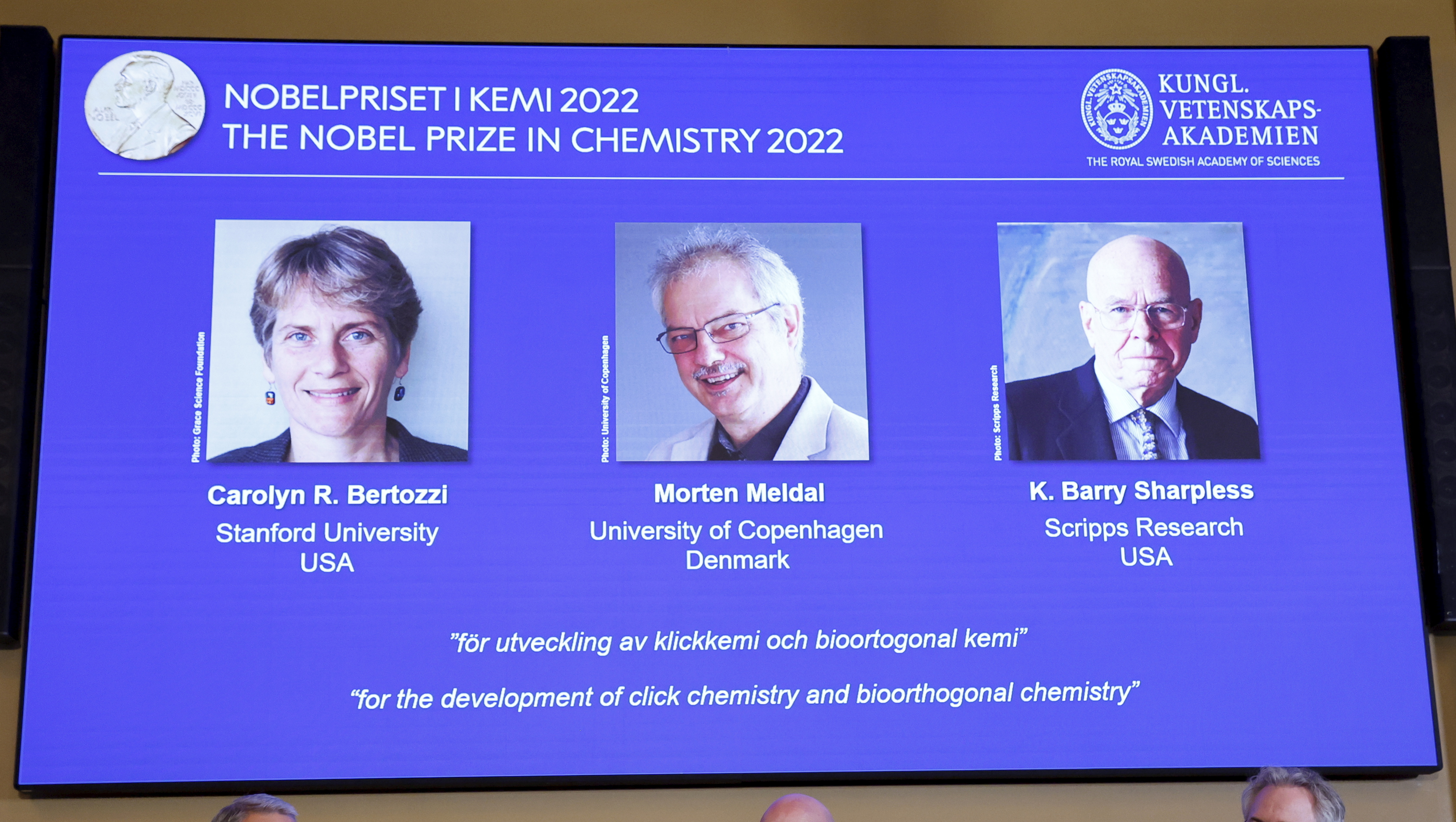 The three winners of the Nobel Prize for chemistry are shown at a press conference at The Royal Swedish Academy of Sciences in Stockholm, Sweden, Wednesday, Oct. 5, 2022. The winners of the 2022 Nobel Prize in chemistry are Caroline R. Bertozzi, USA, Morten Meldal, Denmark and K. Barry Sharpless, USA. (Christine Olsson/TT News Agency via AP)