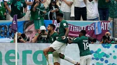 Saudi Arabia's Saleh Al-Shehri, left, celebrates with teammates after scoring his side's first goal during the World Cup group C soccer match between Argentina and Saudi Arabia at the Lusail Stadium in Lusail, Qatar, Tuesday, Nov. 22, 2022. (AP Photo/Ebrahim Noroozi)