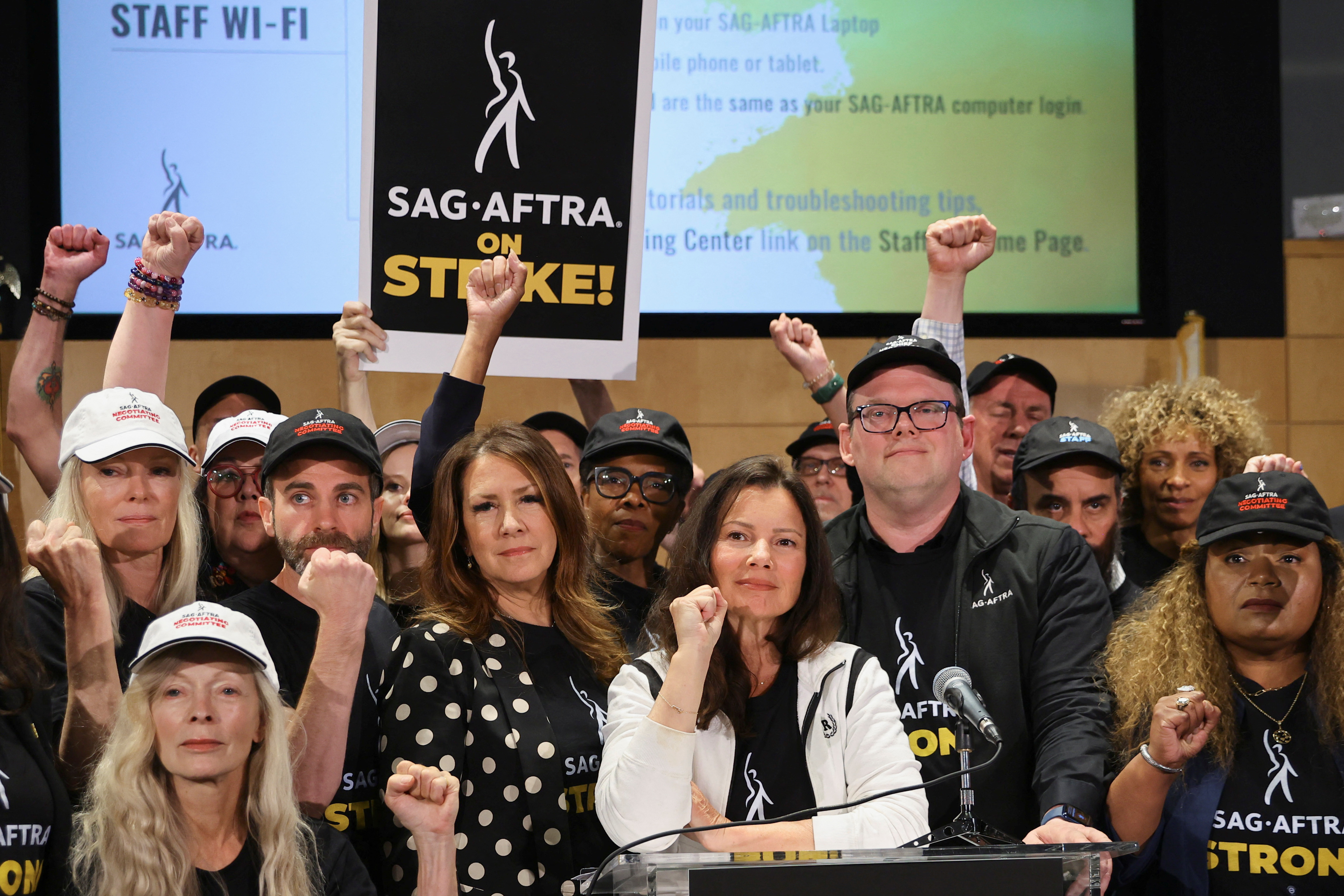 SAG-AFTRA union President Fran Drescher, Duncan Crabtree-Ireland, SAG-AFTRA National Executive Director and Chief Negotiator, and union members gesture at SAG-AFTRA offices after negotiations ended with the Alliance of Motion Picture and Television Producers (AMPTP), the entity that represents major studios and streamers, including Amazon, Apple, Disney, NBCUniversal, Netflix, Paramount, Sony, and Warner Bros Discovery, in Los Angeles, California, U.S., July 13, 2023. REUTERS/Mike Blake
