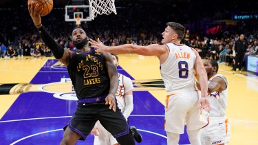 Los Angeles Lakers forward LeBron James, left, shoots as Phoenix Suns guard Grayson Allen defends during the second half of an NBA basketball In-Season Tournament quarterfinal game Tuesday, Dec. 5, 2023, in Los Angeles. (AP Photo/Mark J. Terrill)