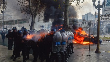Police fire tear gas at anti-government protesters outside Congress, where lawmakers debate a reform bill promoted by Argentine President Javier Milei in Buenos Aires, Argentina, Wednesday, June 12, 2024. (AP Photo/Gustavo Garello)