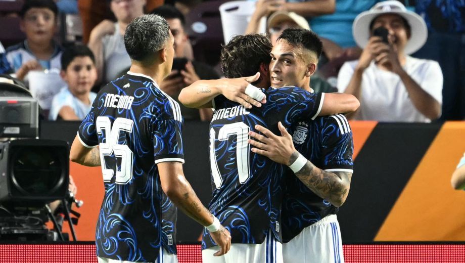 Argentina's forward #22 Lautaro Martinez (R) and Argentina's defender #25 Facundo Medina celebrate with Argentina's forward #17 Giuliano Simeone after he scored a goal during the international friendly football match between Argentina and Honduras at Kyle Field in College Station, Texas on June 6, 2026. (Photo by RONALDO SCHEMIDT / AFP)