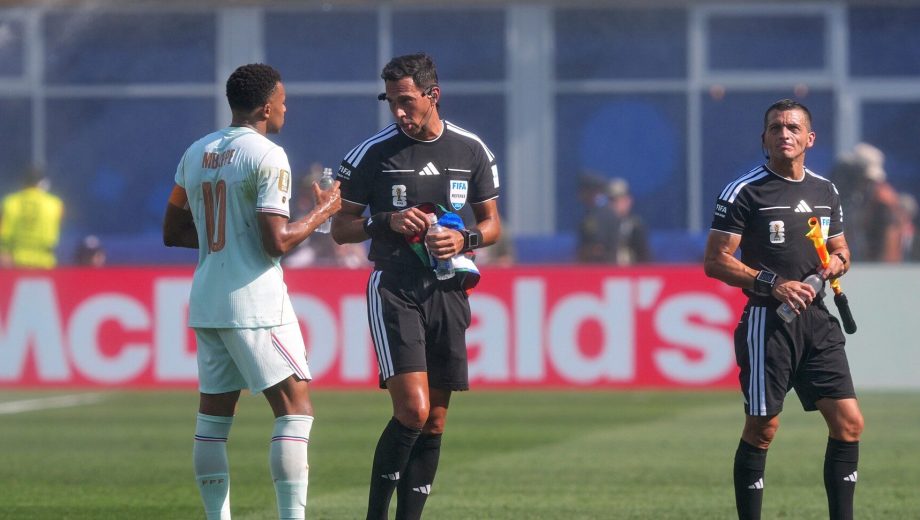 France's Kylian Mbappe (10) talks to referee Facundo Tello after his penalty kick during the World Cup quarterfinal soccer match between France and Morocco in Foxborough, Mass., near Boston, Thursday, July 9, 2026. (AP Photo/Martin Meissner)