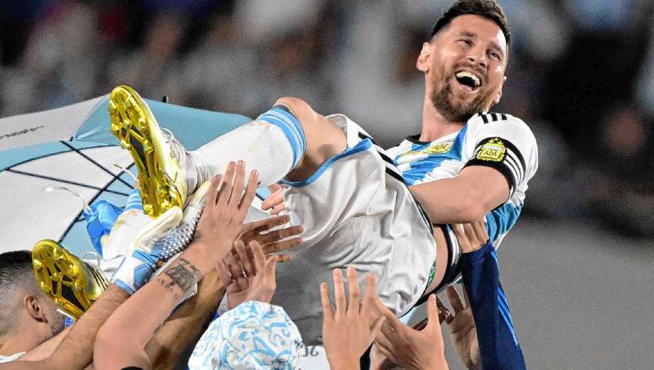 (FILES) Argentina's forward Lionel Messi is thrown up in the air by teammates during a recognition ceremony for the World Cup winning players, following the friendly football match between Argentina and Panama at the Monumental stadium in Buenos Aires on March 23, 2023. Argentine football player Lionel Messi said on August 31, 2026, he is retiring from international football after leading Argentina to a second successive World Cup final. (Photo by JUAN MABROMATA / AFP)